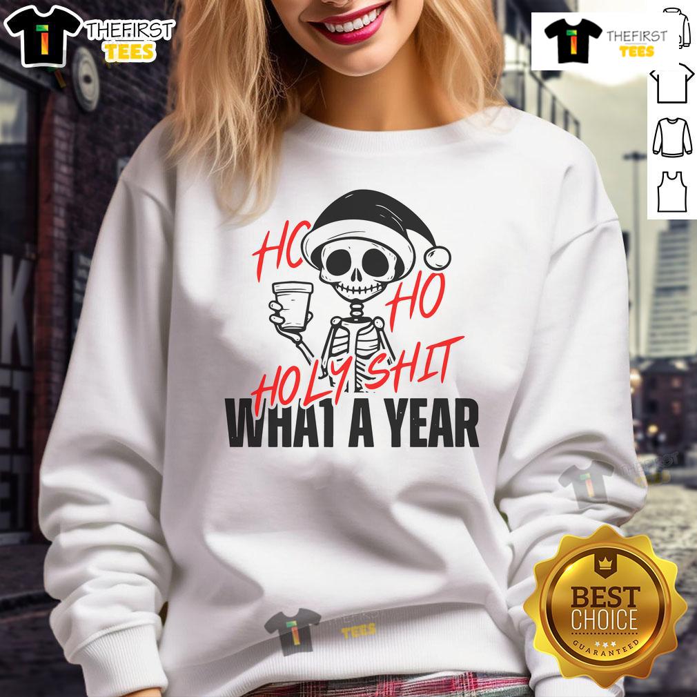 Funny Santa skeleton wearing a Christmas sweatshirt that reads Ho Ho Holy Shit What A Year in festive colors.
