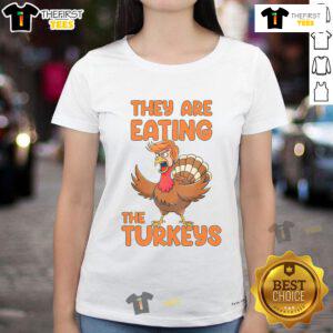 Funny Thanksgiving tee featuring Trump and turkey ladies humorously enjoying turkeys for the holiday.