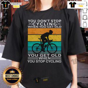 Vintage ladies tee featuring 'You Don't Stop Cycling When You Get Old' design, perfect for biking enthusiasts of all ages.