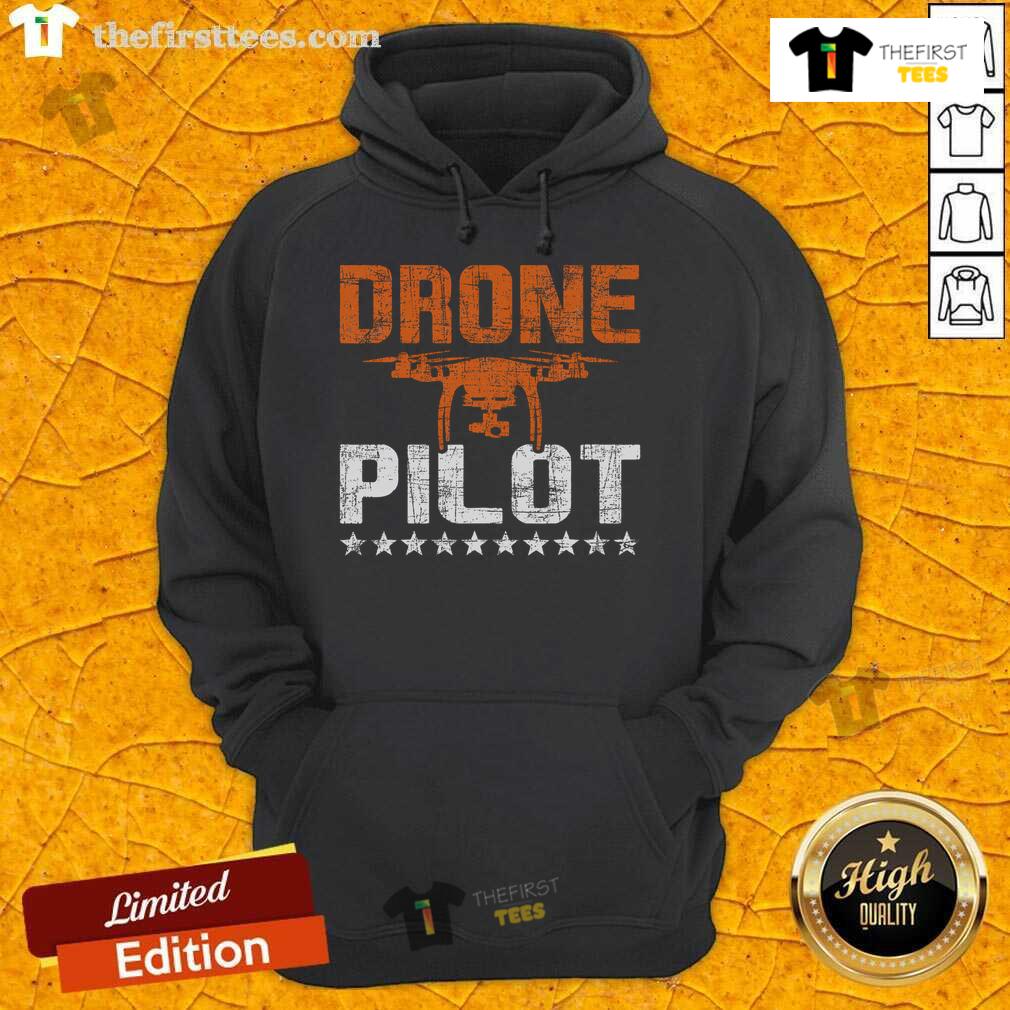 Expert drone pilot wearing a hoodie, skillfully operating a quadcopter in flight, showcasing top drone flying techniques.