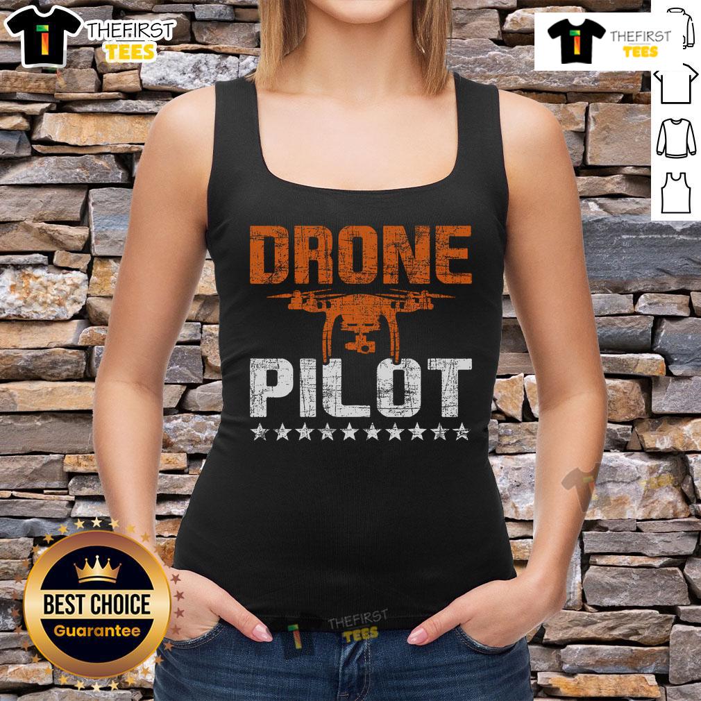 Expert drone pilot in a tank top skillfully flying a quadcopter, showcasing top RC flight operation skills.