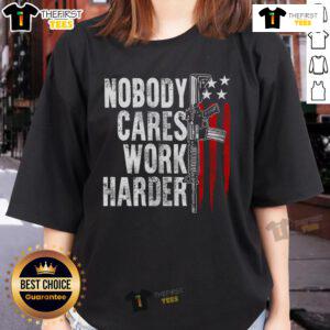 Lady wearing 'Top Nobody Cares Work Harder' AR-15 owner tee with American flag design, showcasing pride and patriotism.