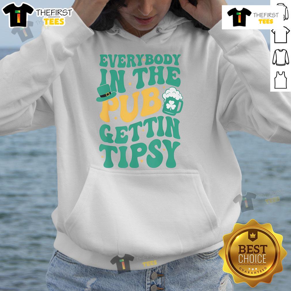 Group of friends in a pub wearing a funny St. Patrick's Day hoodie, enjoying drinks and celebrating tipsy moments.