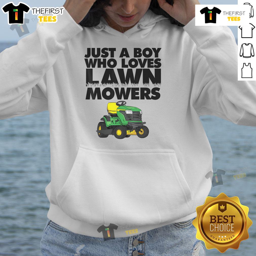 Boy wearing 'Just A Boy Who Loves Lawn Mowers' hoodie, smiling in a sunny garden with a lawn mower in the background.