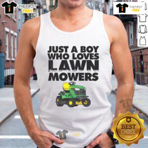 Boy wearing a 'Just a Boy Who Loves Lawn Mowers' tank top, smiling in a sunny backyard with a lawn mower nearby.