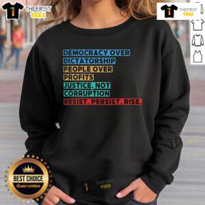 Top Democracy Over Dictatorship sweatshirt featuring bold messages of justice, resistance, and prioritizing people over profits.