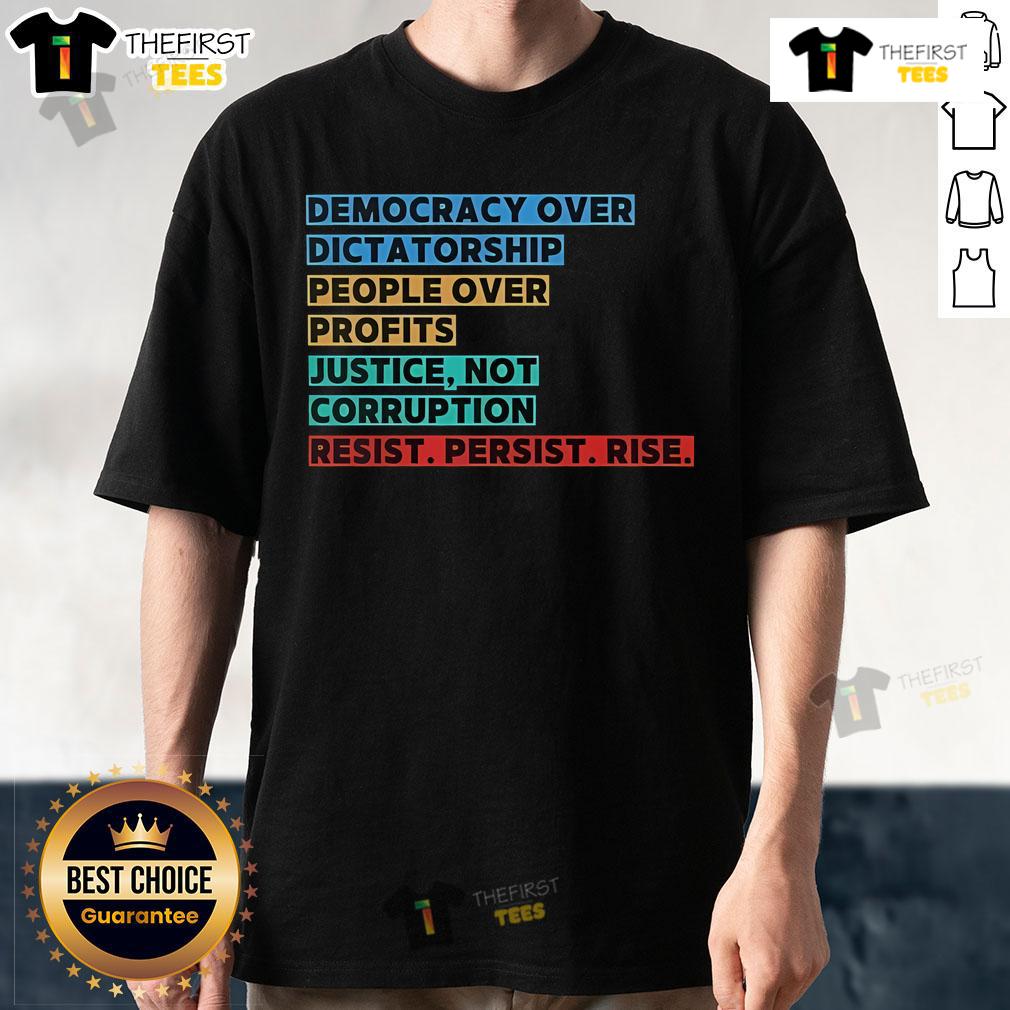Protest T-shirt featuring 'Top Democracy Over Dictatorship' slogan, promoting justice, resistance, and people over profits.