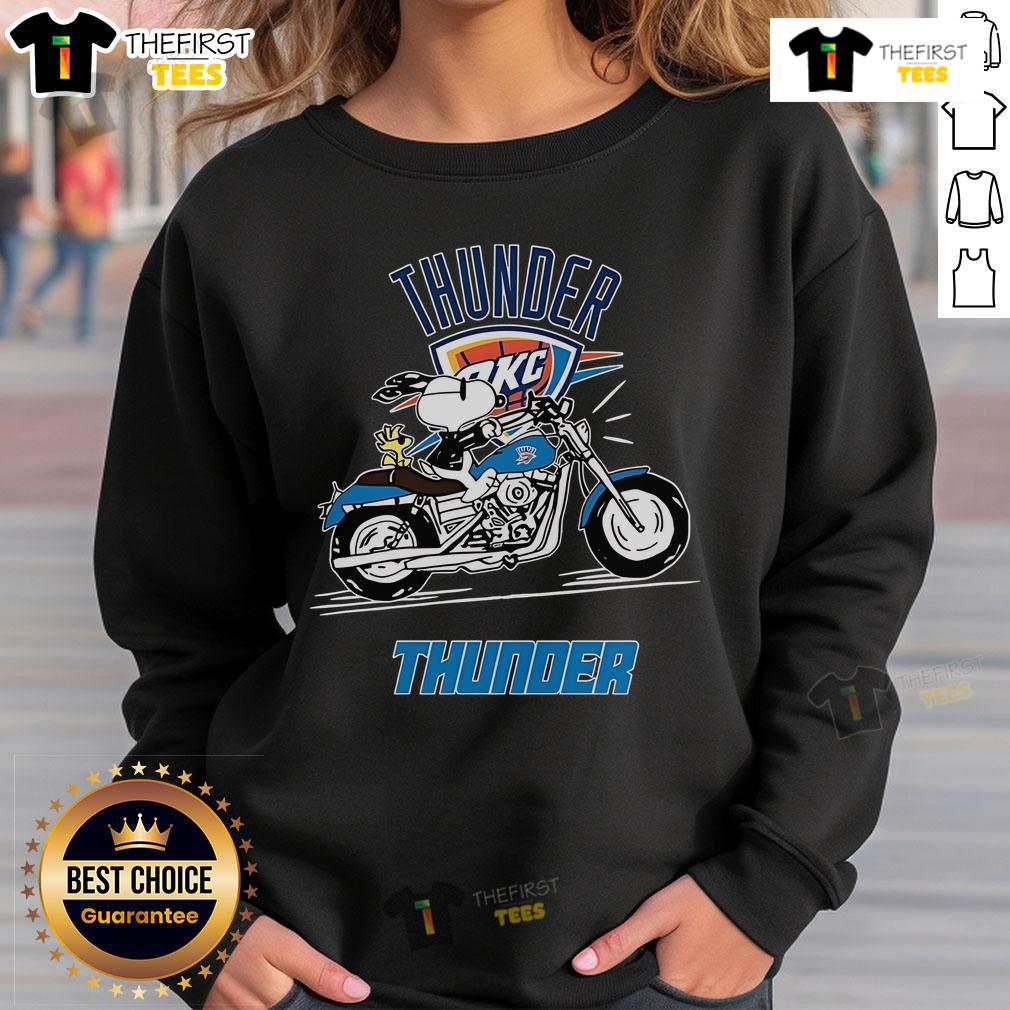 Official Snoopy and Woodstock driving a motorbike on Oklahoma City Thunder sweatshirt, vibrant team colors design.