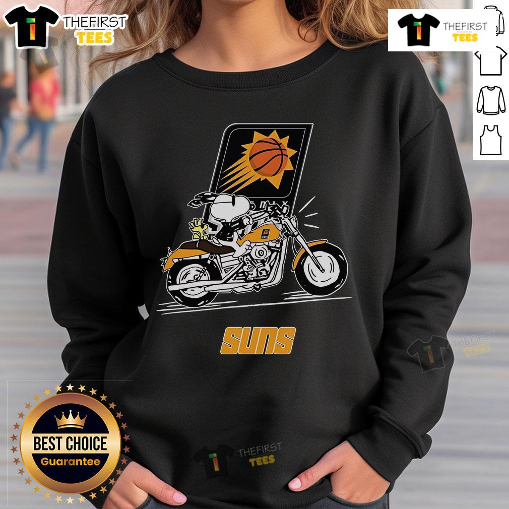 Alt Text: Official Snoopy and Woodstock driving motorbike on Phoenix Suns sweatshirt, showcasing vibrant team spirit and fun design.