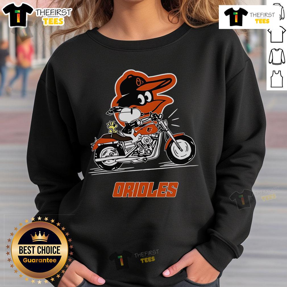 Alt Text: Original Snoopy and Woodstock driving a motorbike on a Baltimore Orioles sweatshirt, showcasing playful cartoon design.