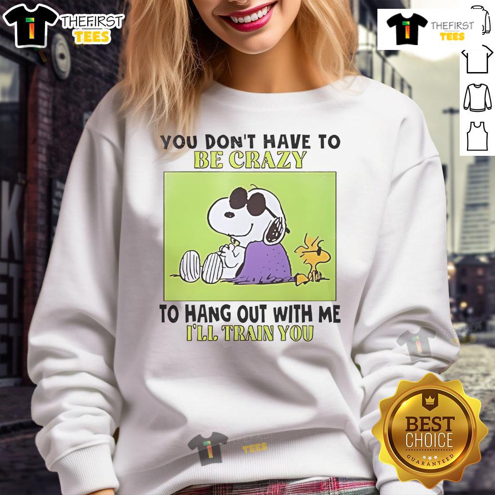 Alt Text: Cozy sweatshirt featuring Snoopy and Woodstock with the quote You don't have to be crazy to hang out with me.