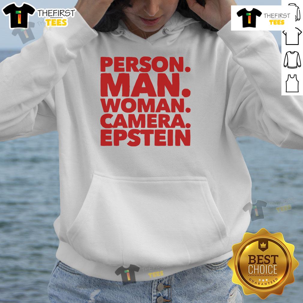 Friendly man and woman wearing Epstein hoodies, posing together with a camera in a vibrant urban setting.