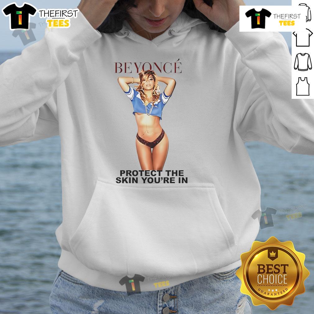 Alt Text: Beyonc wearing the official 'Protect The Skin You're In' hoodie, promoting skin positivity and self-love fashion.