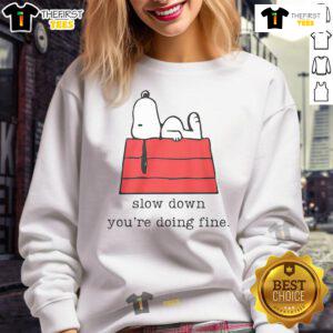 Alt Text: Cute motivational Snoopy sweatshirt with 'Slow Down, You're Doing Fine' text for a cozy, inspiring look.