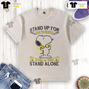 Alt Text: Cute Snoopy stand-up graphic on a washed t-shirt, inspiring message to stand for what you believe in, even alone.