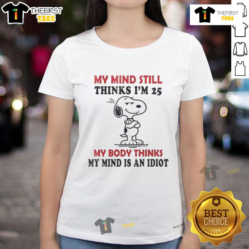 Funny Snoopy ladies tee with 'My mind thinks I'm 25, my body thinks I'm an idiot' text, perfect for playful humor lovers.
