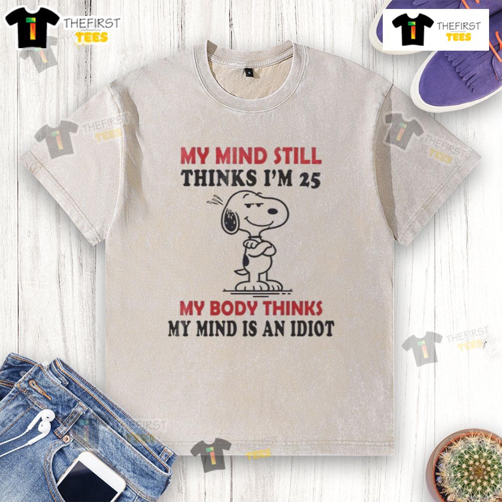 Funny Snoopy graphic on a washed t-shirt: 'My mind thinks I'm 25, my body thinks I'm an idiot.' Perfect for humor lovers!
