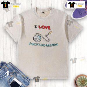 Good I Love Crotch Eating washed t-shirt displayed on a hanger, showcasing its unique design and vibrant colors.