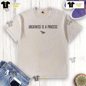 Official Paper Plane Greatness Is A Process washed t-shirt displayed on a hanger, featuring a stylish design and soft fabric.