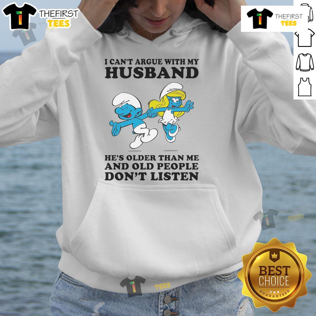 Woman wearing Official The Smurfs 'I Can't Argue With My Husband He's Older Than Me' hoodie, showcasing fun and humor.