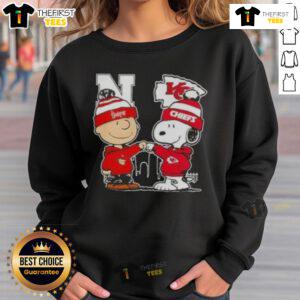Top Snoopy and Charlie Brown Nebraska Huskers x Kansas City Chiefs skyline sweatshirt featuring vibrant graphics.