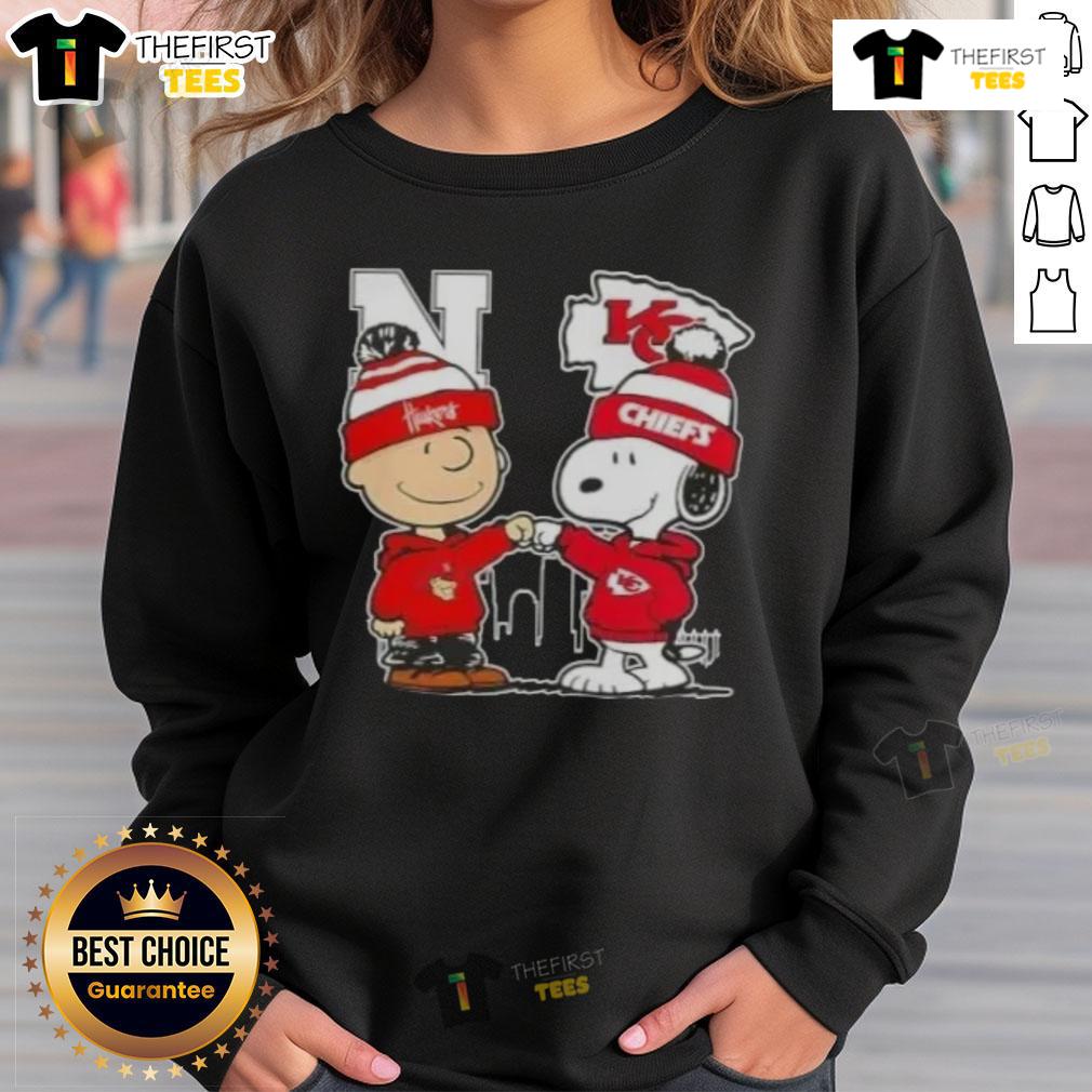 Top Snoopy and Charlie Brown Nebraska Huskers x Kansas City Chiefs skyline sweatshirt featuring vibrant graphics.