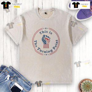 Charlie Kirk fist raised in front of a US flag on a washed t-shirt, symbolizing patriotism and activism. Shop now!