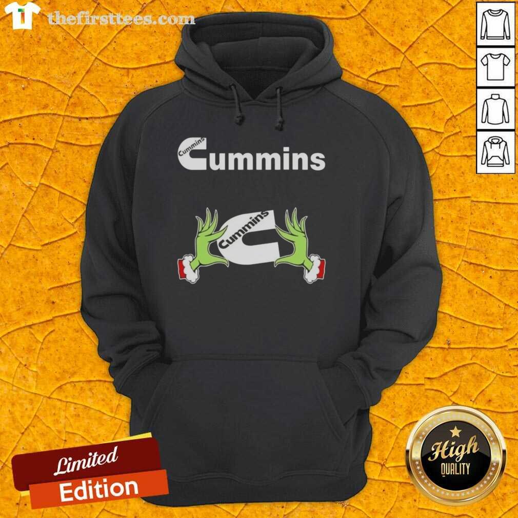 Alt Text: Funny Grinch hands holding a Cummins Christmas hoodie, perfect for festive celebrations and holiday cheer.