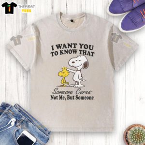 Alt Text: Happy Snoopy on a 'Someone Cares' T-shirt, showcasing cheerful design and message for those in need of support.