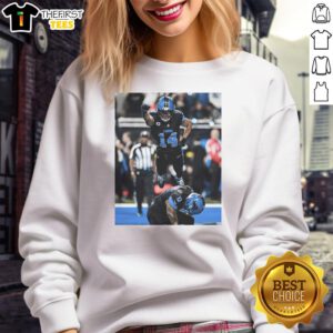Alt Text: Official Detroit Lions Spiderman Amon-Ra St. Brown Superman sweatshirt featuring vibrant graphics and team colors.