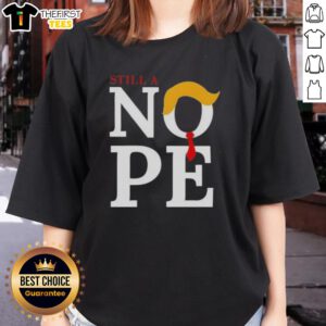 Womens tee featuring 'Top Still A Nope Trump Hair' graphic, perfect for political humor enthusiasts and casual wear.