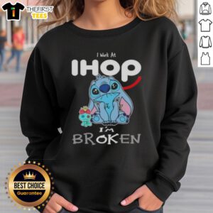 Cute Stitch sweatshirt with 'I work at IHOP, I'm broken' design, perfect for fans of Disney and cozy fashion.