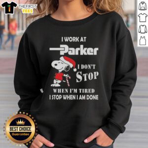 Alt Text: Cute Snoopy Christmas sweatshirt for Parker Hannifin employees, featuring I don't stop when I'm tired, I stop when I'm done.