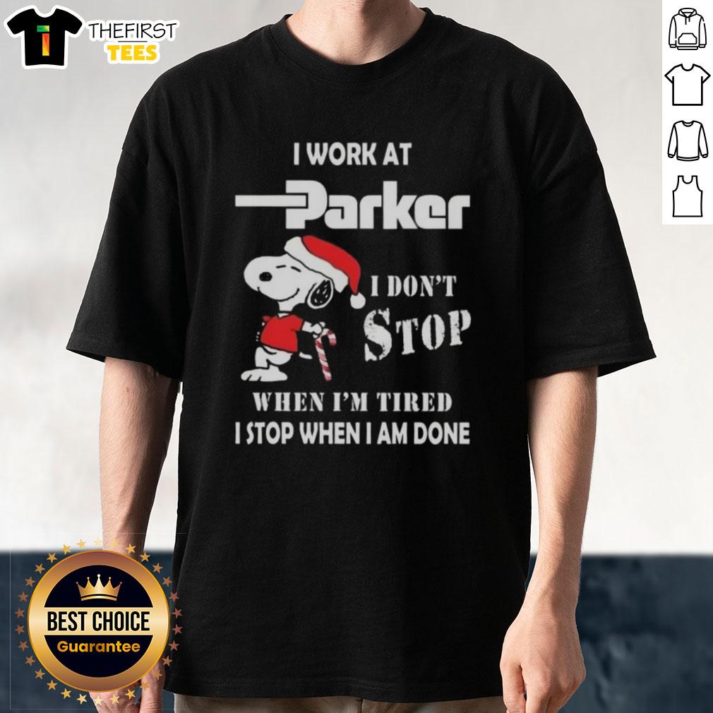 Alt Text: Cute Snoopy graphic T-shirt featuring I Work At Parker Hannifin I Dont Stop When Im Tired for Christmas.