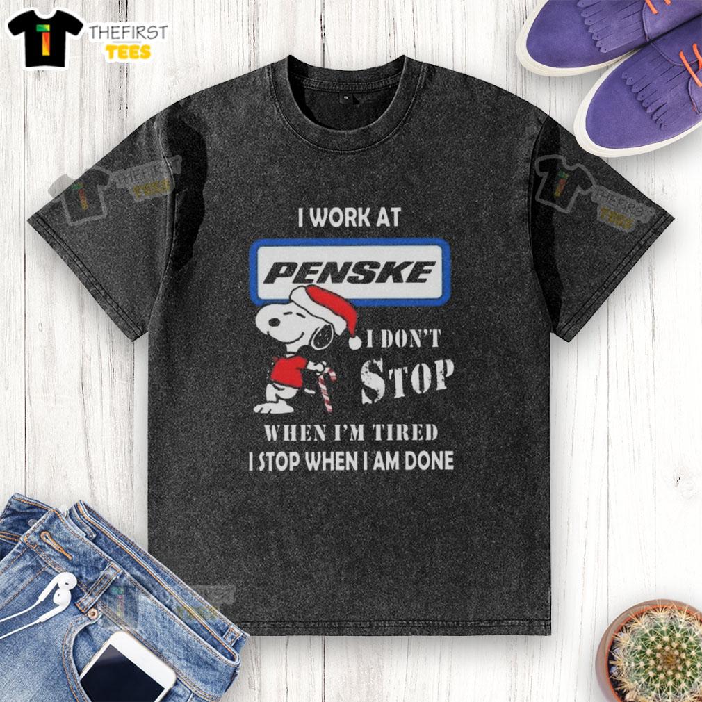 Cute Snoopy I Work At Penske Corporation T-Shirt featuring a motivational quote for Christmas, perfect for holiday gifting.