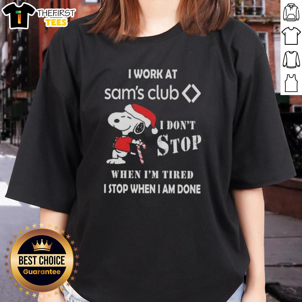 Alt Text: Cute Snoopy Christmas ladies tee with 'I work at Sam's Club. I don't stop when I'm tired; I stop when I'm done.'