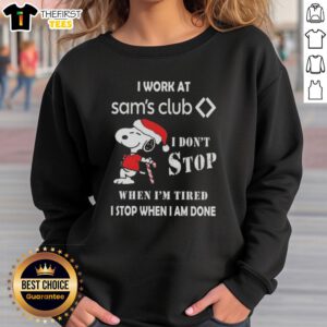Cute Snoopy Christmas sweatshirt with text: 'I work at Sam's Club, I don't stop when I'm tired, I stop when I'm done.'