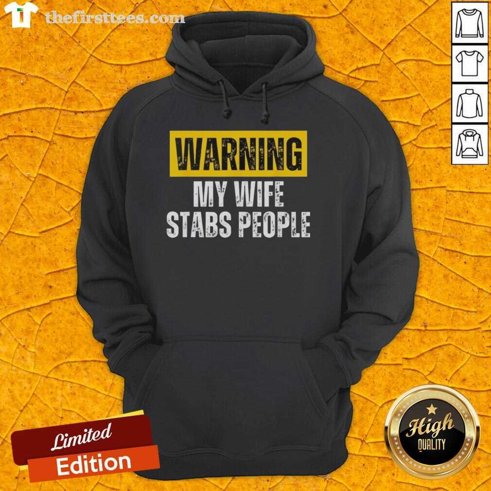 Alt Text: Vintage hoodie featuring the phrase Official Warning: My Wife Stabs People for a humorous gift idea.