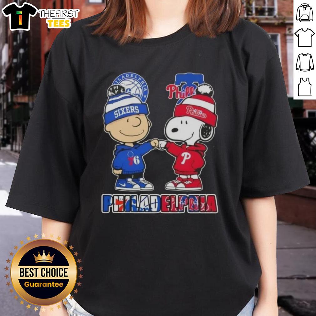 Alt Text: Pretty Charlie Brown fist bump with Snoopy, featuring Philadelphia City Sports 76ers x Phillies ladies tee design.