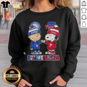 Pretty Charlie Brown fist bump with Snoopy on a Philadelphia City Sports 76ers x Phillies sweatshirt.