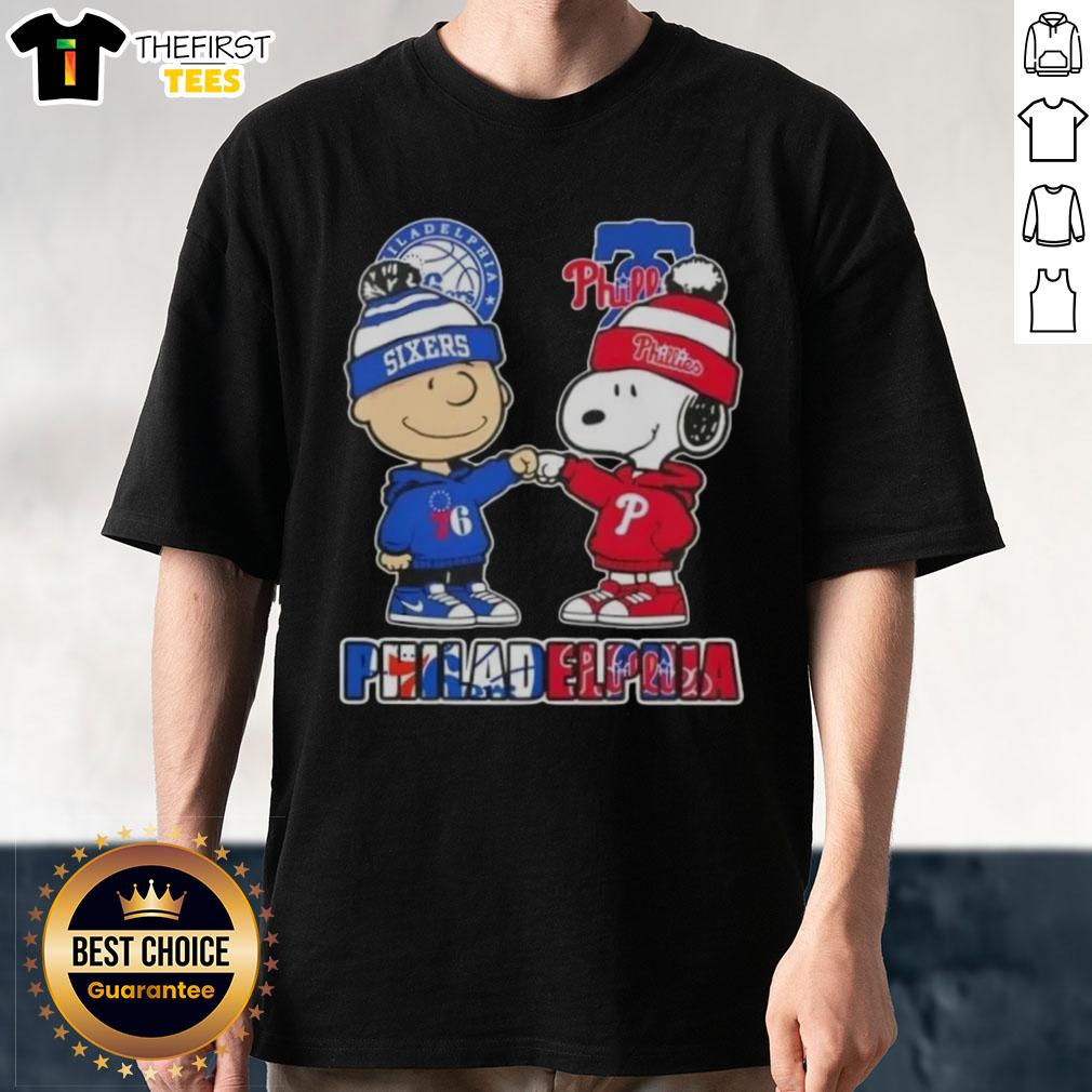 Pretty Charlie Brown fist bump with Snoopy on a Philadelphia 76ers and Phillies T-shirt, perfect for city sports fans.