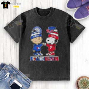 Pretty Charlie Brown fist bump with Snoopy on a Philadelphia sports t-shirt featuring 76ers and Phillies logos.