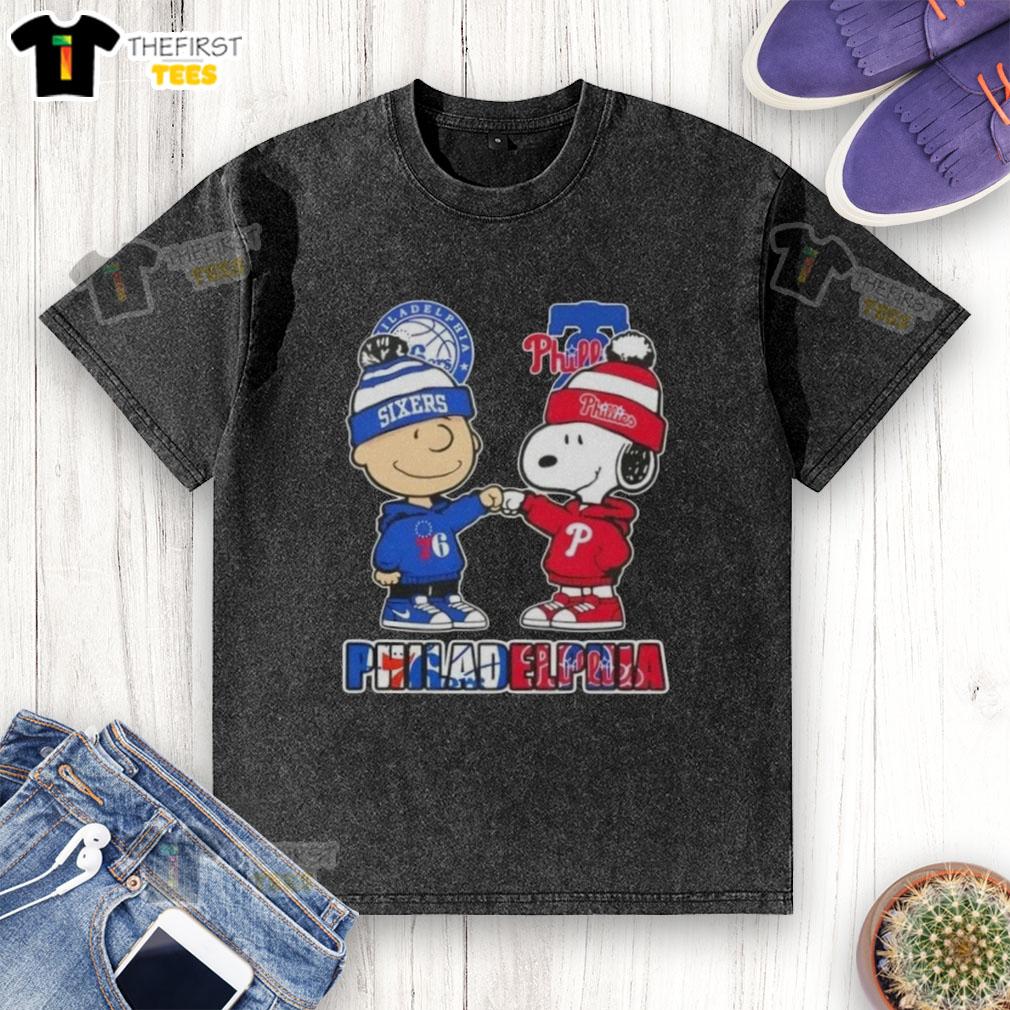 Pretty Charlie Brown fist bump with Snoopy on a Philadelphia sports t-shirt featuring 76ers and Phillies logos.