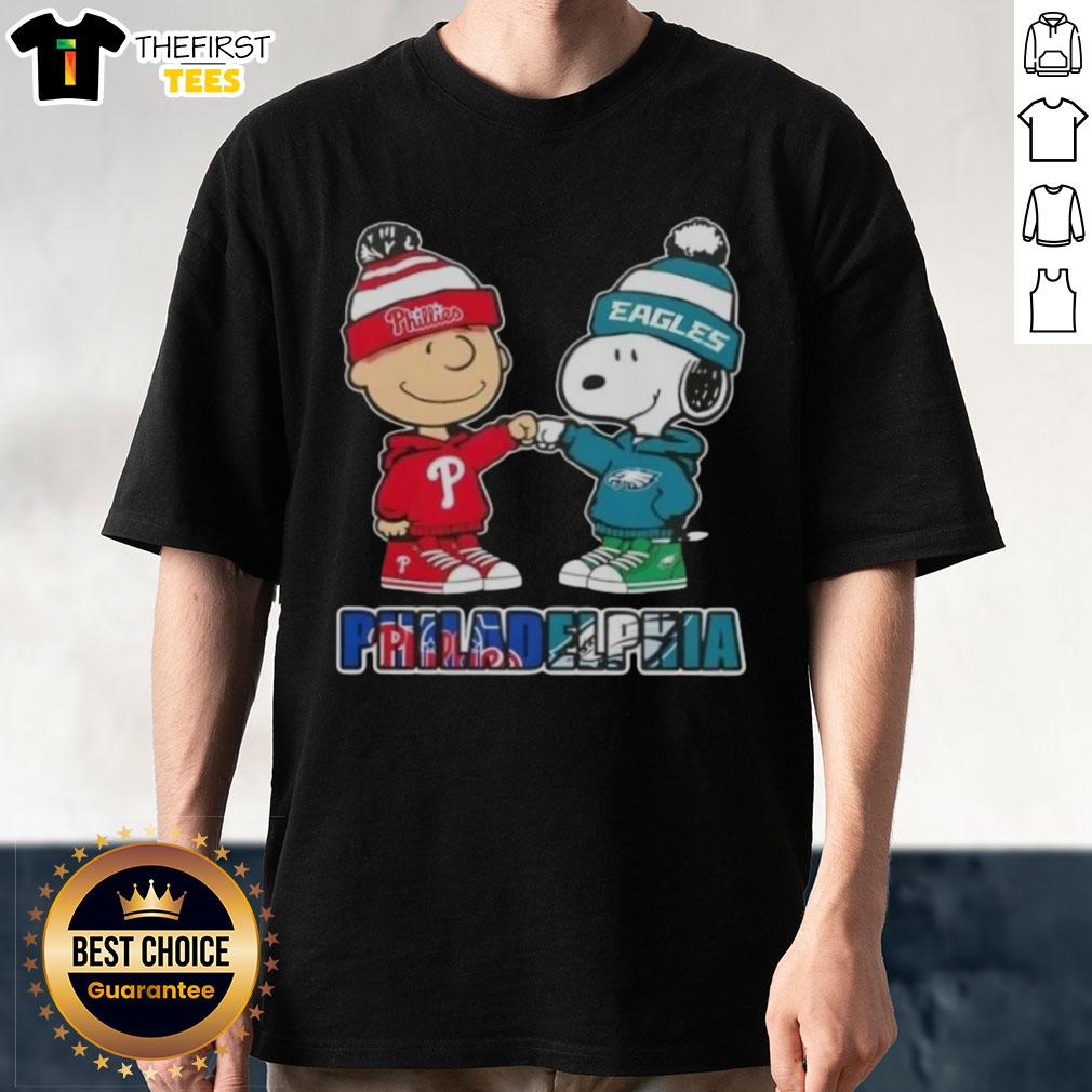 Pretty Charlie Brown fist bumping Snoopy on a Philadelphia City Sports Phillies X Eagles T-Shirt design.