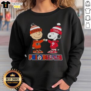 Pretty Charlie Brown fist bump with Snoopy on a Philadelphia sports sweatshirt featuring Phillies and Flyers logos.