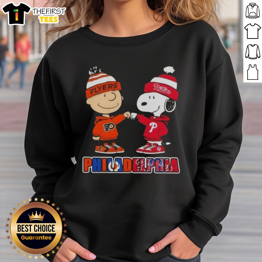 Pretty Charlie Brown fist bump with Snoopy on a Philadelphia sports sweatshirt featuring Phillies and Flyers logos.