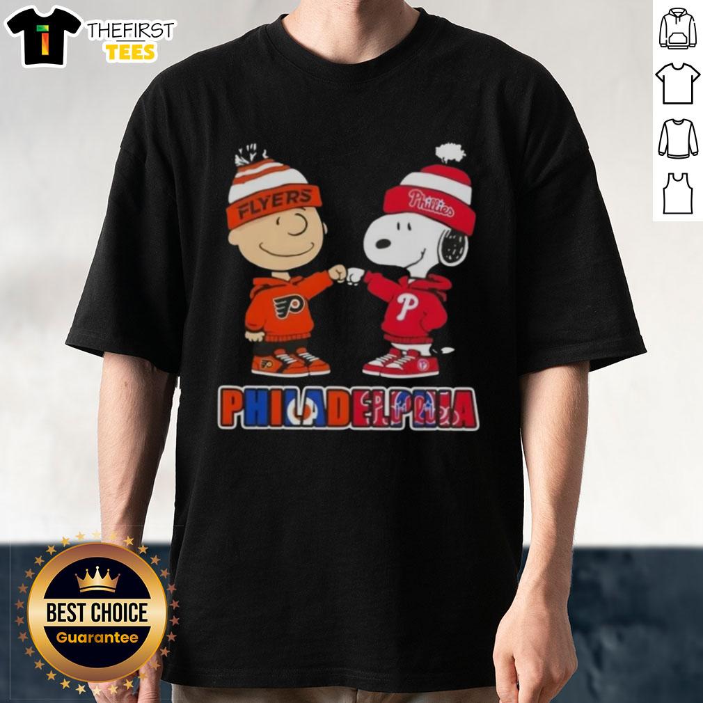 Pretty Charlie Brown fist bump with Snoopy on a Philadelphia sports T-shirt featuring Phillies and Flyers logos.
