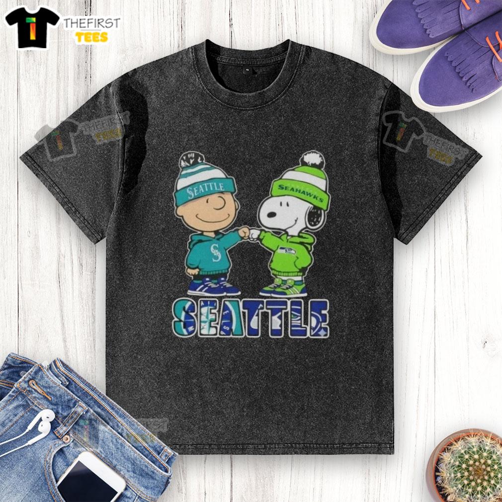 Pretty Charlie Brown fist bump with Snoopy, featuring Seattle Mariners and Seahawks logos on a washed t-shirt.