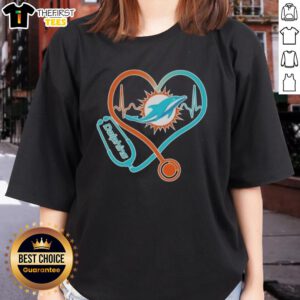 Alt Text: Ladies' Miami Dolphins Tee featuring stethoscope and headphones, perfect for passionate fans.