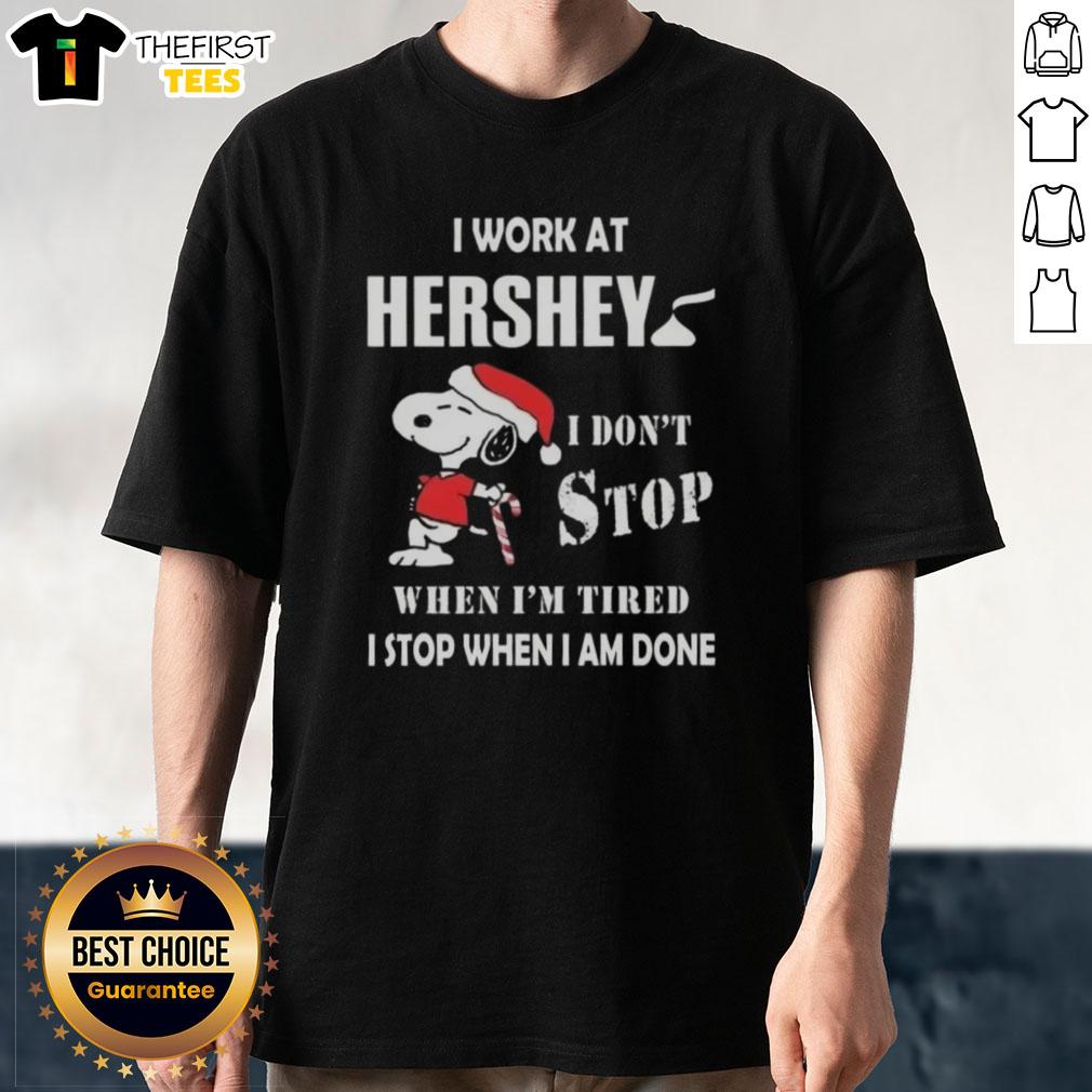 Top Snoopy I Work At Hershey Christmas T-Shirt with a motivational quote: 'I Dont Stop When Im Tired, I Stop When I Am Done.'